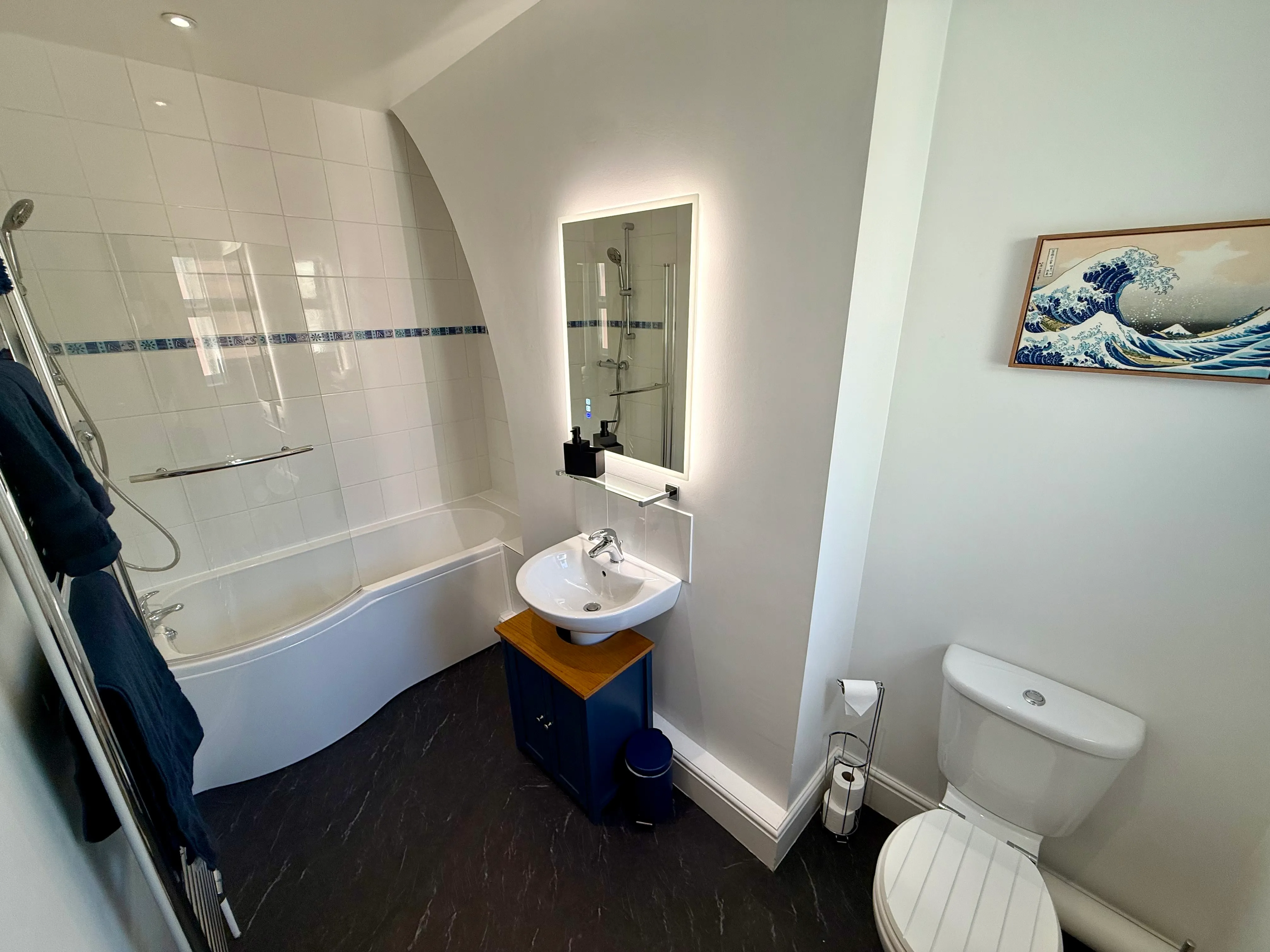 The family bathroom with bath and overhead shower