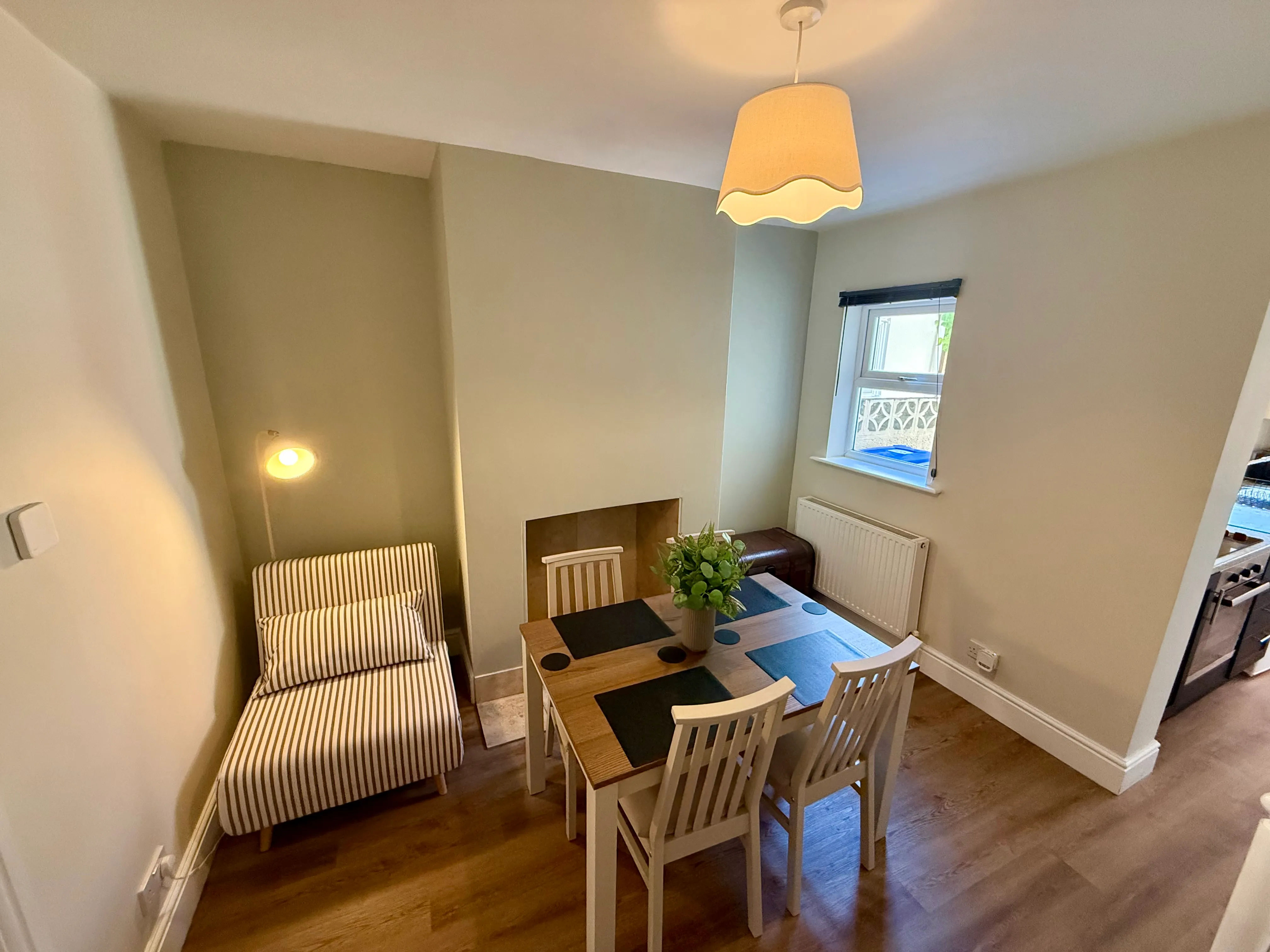 The dining room with a table for four and pull-out chair bed