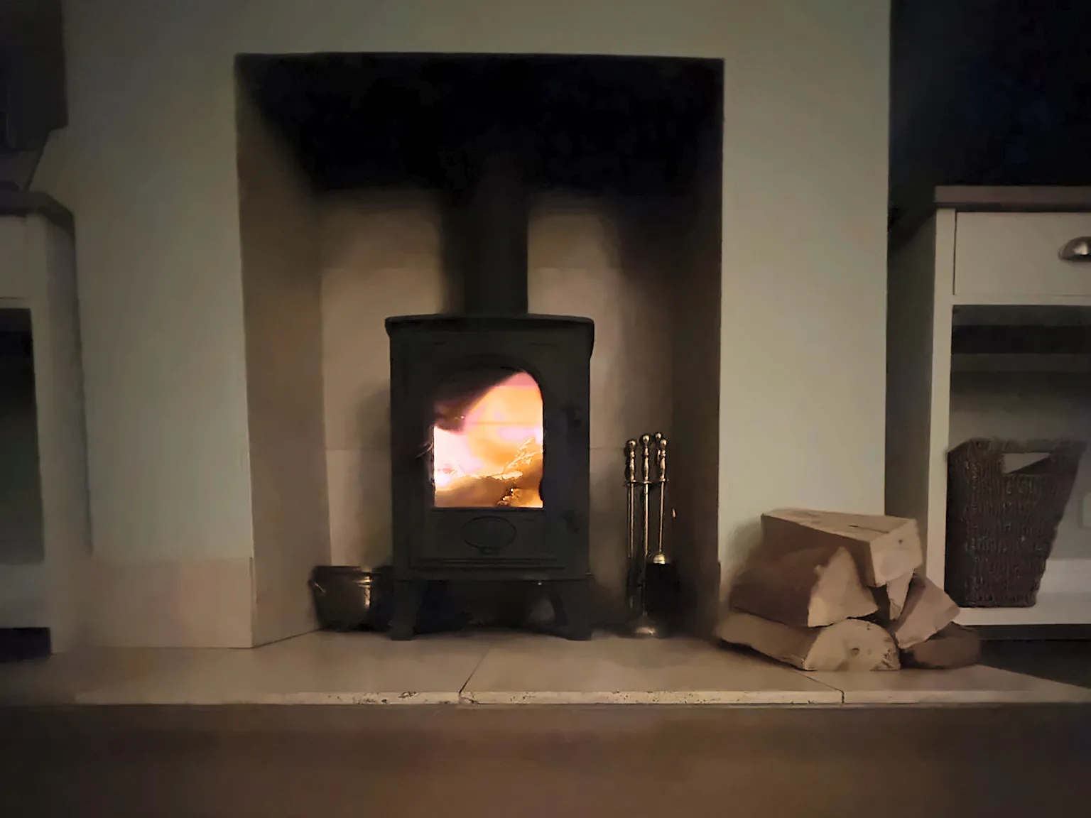 The log burner alight in the sitting room fireplace